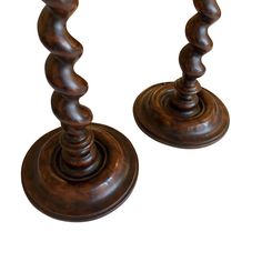 two wooden candlesticks sitting next to each other