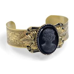 "Don't let anyone know this isn't a family heirloom. In time, and because of its association with you, it will become one. A circa 1930s art glass cameos rests upon acanthus leaves, symbol of life and vitality. Behind it, a frame of black enamel and marcasite stones is mounted on a wide bracelet band with Florentine tracery. In the early days of Sweet Romance Jewelry Mfg, I bought caches of glass elements that had been made in Austria, Germany and Czechoslovakia between the world wars. I bought Victorian Bracelet, Cameo Bracelet, Symbol Of Life, Jewelry Victorian, Bronze Bracelets, Slide Bracelet, Acanthus Leaves, Art Deco Bracelet, Antique Bracelets