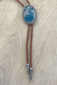 This awesome bolo features a rabbit design. It is solid stainless steel metal backing with an inlaid rabbit print covered in resin. Handmade in our shop. Quality guaranteed, picture does not do this bolo justice! The piece measures 1 1/2'' x 1 1/4''. It can adjust lengths, 39'' in total length.   We have matching belt buckles to pair! Western Gifts, Country Rings, Bolo Ties, Mens Necklace, Bolo Tie, Men's Necklace, Pitcairn Islands, Guinea Bissau, Mozambique