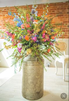 a vase filled with colorful flowers on top of a wooden table