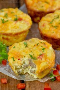 several mini quiches on wax paper with parsley sprinkled around the edges