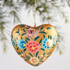 a heart shaped ornament hanging from a tree