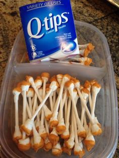 a plastic container filled with marshmallows next to a package of o - tips