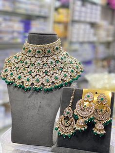 two pieces of jewelry on display in a store