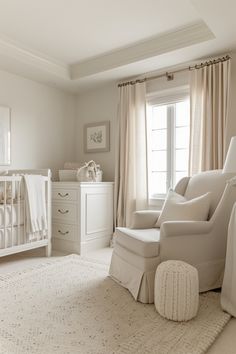 a baby's room with white furniture and curtains