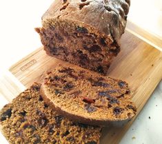 a loaf of bread sitting on top of a wooden cutting board