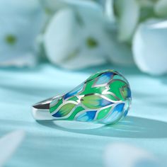 How beautiful is this sweet spring ring? The ring features flowers and leaves that wrap around your finger, detailed with bright enamel for lovers of colour! The perfect accessory for spring and summertime, or to keep the floral vibe going all year round.Carat Weight: 0.072 ctStone Size: 1.4 mmNumber of Stones: 3 Stone Shape: RoundStone Color: Diamond WhiteWeight: 4.79 gWidth: 3.7 mmHeight: 7.7 mmThickness: 1.6 mmMaterial: 925 SilverPlating Color: Silver Enamel Jewelry For Spring Gifts, Spring Enamel Jewelry As Gift, Spring Enamel Jewelry For Gifts, Hand Painted Jewelry As Spring Gift, Hand Painted Jewelry For Spring Gift, Spring Gift Enamel Jewelry, Green Rings As Summer Gift, Green Rings Suitable For Summer Gifts, Green Rings For Summer Gifts