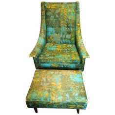 an upholstered green chair and ottoman