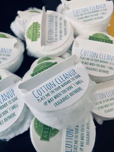 several cotton cleaning soaps are stacked on top of each other with labels attached to them