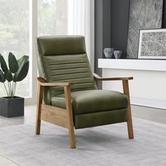 a green leather recliner chair sitting on top of a rug next to a potted plant