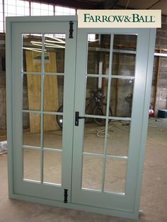 two glass doors with the words farrow and ball on them