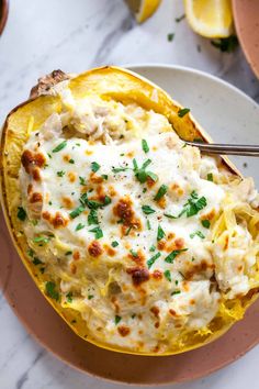 a bowl filled with pasta and cheese on top of a plate