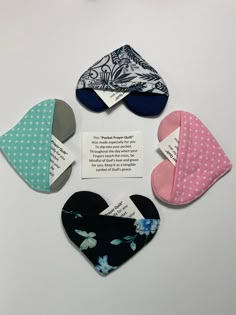 four hearts with different designs on them and a note attached to the back of each heart