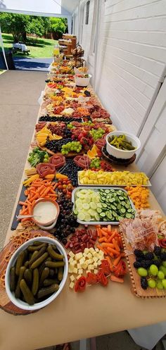 a long table filled with lots of different types of food on it's sides