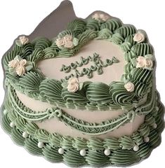 a green and white cake with flowers on it