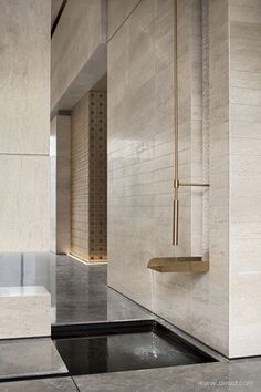 a bathroom with a sink, mirror and shower head on the wall next to it