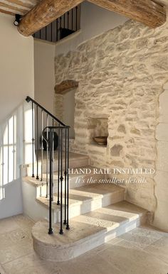 an old stone building with stairs leading up to the second floor and another room in the background