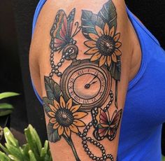 a woman's arm with a clock and sunflowers on it