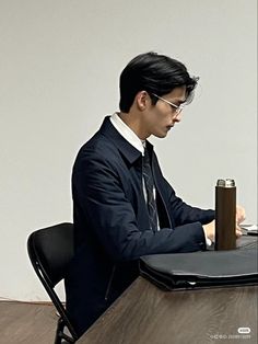 a man sitting at a table using a laptop computer