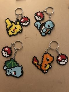 six pixel keychains are arranged in the shape of pokemons and pikachu