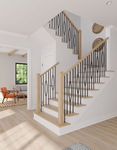 a staircase in a house with white walls and wood floors