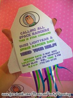 someone is holding up a card that says, calling all space rangers this is star command buzz lightyear & space ranger day