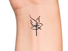 a wrist tattoo with a bird on it's side and a cross in the middle