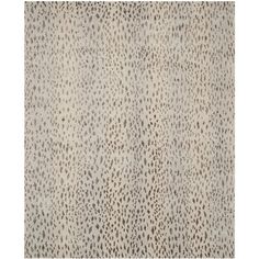 an animal print area rug in grey and white with black spots on the top of it