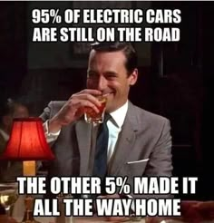 a man in a suit and tie drinking from a glass with the caption 99 % of electric cars are still on the road