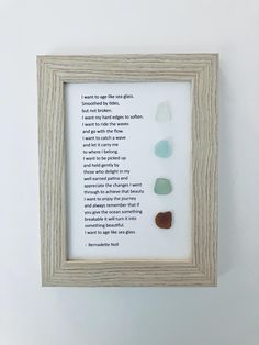 a framed poem with sea glass in it