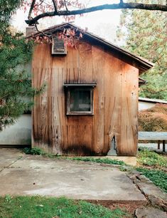 a small wooden building with a window on the side