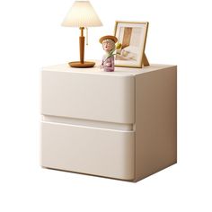 a white cabinet with a lamp on top and a picture frame sitting next to it