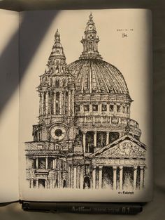 an open book with a drawing of a building