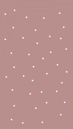 a pink and white polka dot wallpaper with small dots on the bottom half of it