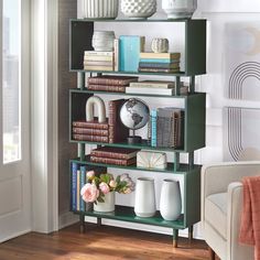 a book shelf filled with books and vases