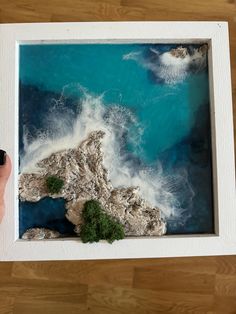 an aerial view of the ocean with rocks and seaweed in it, taken from above