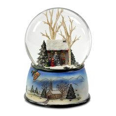 a snow globe with a house and trees inside