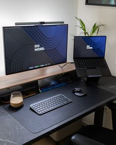 two computer monitors sitting on top of a desk next to a keyboard, mouse and monitor