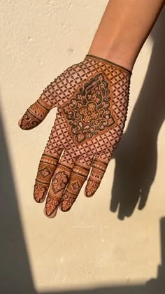 a woman's hand with henna on it