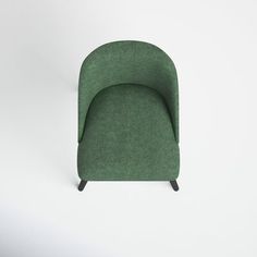 a green chair sitting on top of a white floor