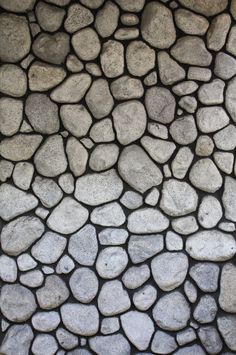 the stone wall is made up of small rocks