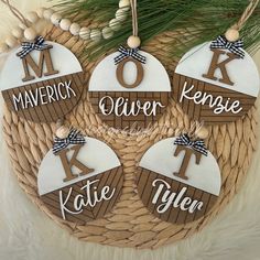 four personalized christmas ornament hanging from a basket