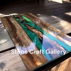 a wooden table topped with a painting on top of it