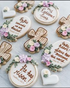 decorated cookies are arranged on a table with flowers and hearts in the center, along with words that spell out their names