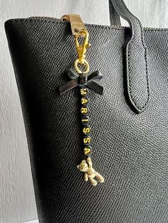 a black handbag with a gold chain hanging from it