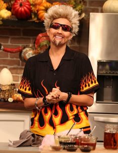 a woman with blonde hair standing in front of a stove