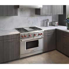 a stove top oven sitting inside of a kitchen