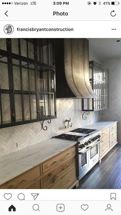 a kitchen with wooden cabinets and white marble counter tops, an oven top and range hood