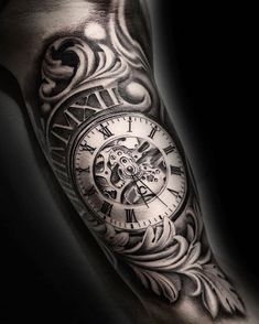 a man's arm with an intricate clock tattoo on the forearm and hand area