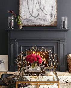 a living room filled with furniture and a painting on the wall above a fire place